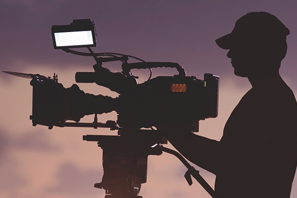 man operating a video camera